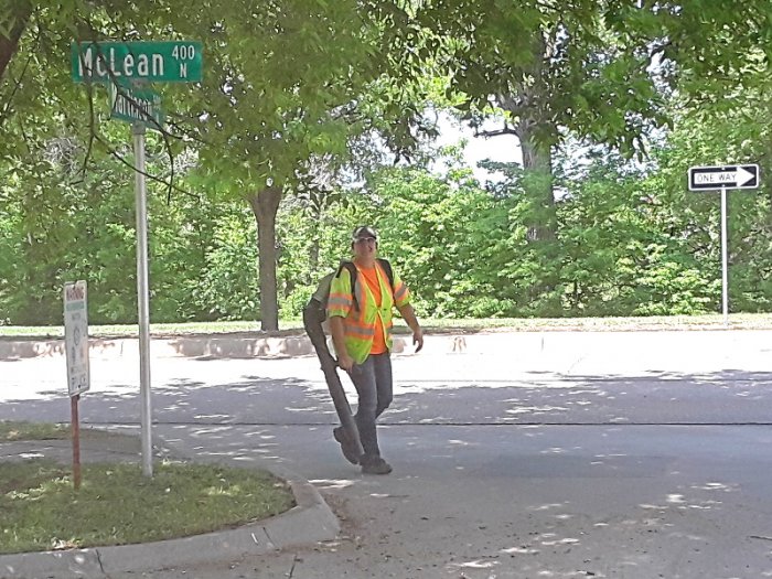 City contractor blowing grass clippings into street